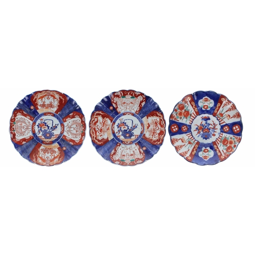 842 - Three similar Japanese Imari fluted porcelain wall chargers, each with foliate designs in typical pa... 