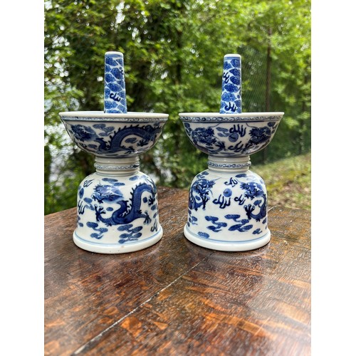 838 - Pair of Chinese export blue and white porcelain candlesticks, of double bowl form decorated with dra... 