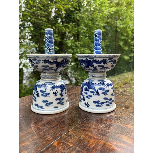 838 - Pair of Chinese export blue and white porcelain candlesticks, of double bowl form decorated with dra... 