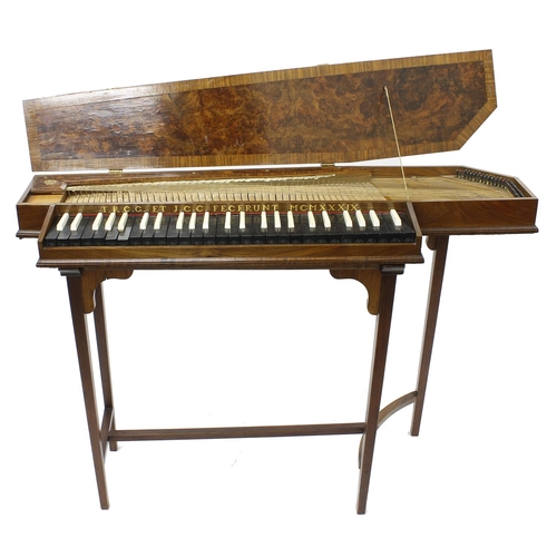 Fine English burr walnut and crossbanded polygonal unfretted clavichord by Thomas Goff and Joseph Cobby and inscribed in gold lettering on the fascia board T.R.C.G. et J.C.C. Fecerunt MCMXXXIX, the four octave and two note keyboard, C to d3, with ebony naturals and ivory incidentals, single string, within a foliate pierced brass hinged burr walnut and crossbanded case, 40" long overall, 13" wide (max), upon a mahogany folding stand with tapering square legs united by a stretcher; also within a travelling case inscribed in gold lettering Captain T.R.C. Goff, Scots Guards.