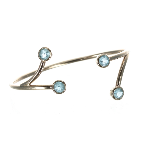 154 - Bespoke design 9ct blue topaz set sprung bangle, 14.5gm