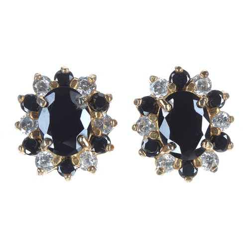 158 - Pair of 18ct yellow gold sapphire and diamond oval cluster earrings, with a border of round brillian... 