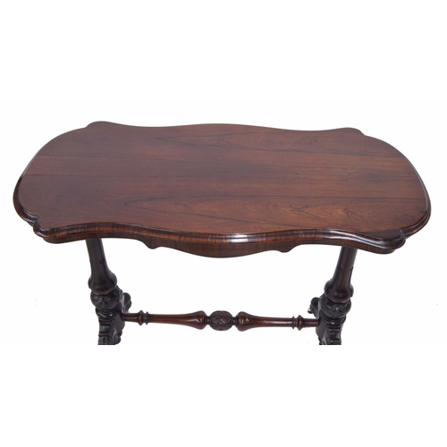 1022 - Victorian rosewood serpentine stretcher side table, the moulded top over a shaped apron, raised on t... 