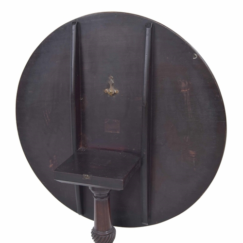 1032 - Georgian mahogany circular occasional table, the plain tilt top raised on a central carved pillar su... 