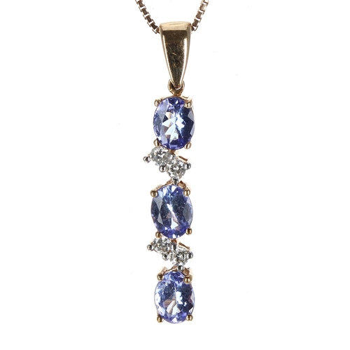 200 - Modern 9ct tanzanite and diamond pendant upon slender 9ct chain, set with three oval tanzanite stone... 