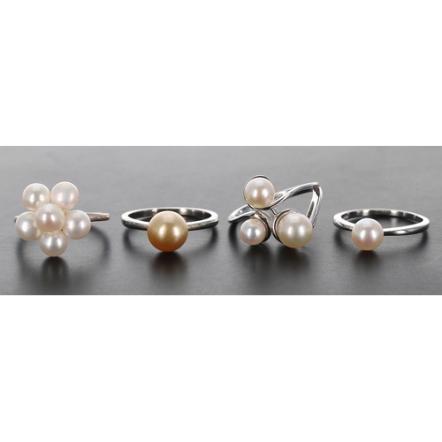 373 - Four modern silver pearl set rings, 14.5gm in total (4)