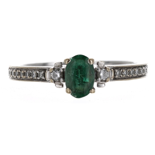 355 - 18ct white gold emerald and diamond ring, the oval emerald 0.45ct approx, diamond set shoulders, wid... 