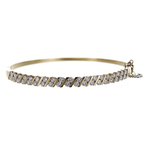 422 - Diamond set yellow gold hinged bangle, round brilliant-cuts, 1.15ct approx in total, with safety cha... 