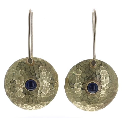 244 - Pair of circular hammered 18ct earrings set with single cabouchon sapphires, hook backs, 9gm, 43mm... 