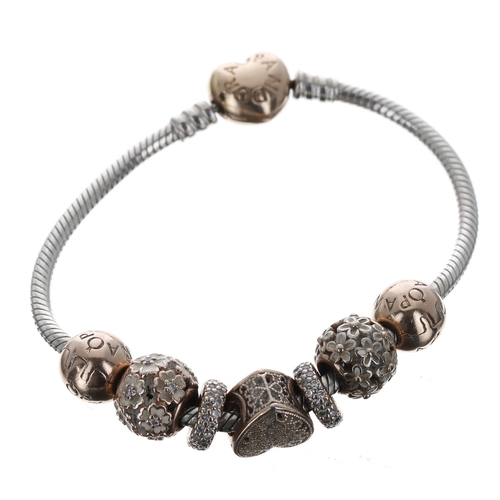 213 - Pandora silver bracelet with a rose gold plated clasp and seven assorted charms, 28.8gm, boxed... 