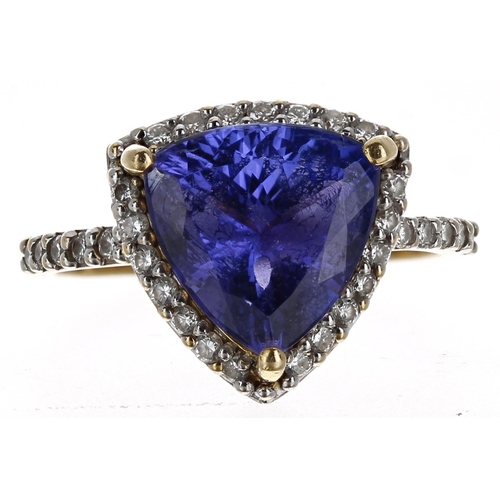 230 - Impressive 18ct tanzanite and diamond trilliant-cut ring with set shoulders, the tanzanite of good c... 