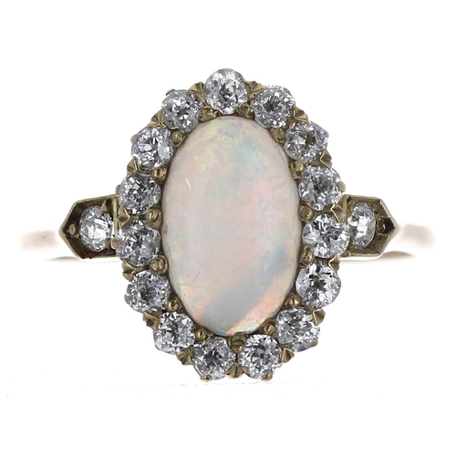 235 - Pretty 18ct cabouchon opal and diamond oval cluster ring, the opal 1.00ct approx, in a border of rou... 