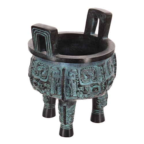 857 - Chinese twin-handled cast bronze tripod censor, with carved archaic style decoration, the interior w... 