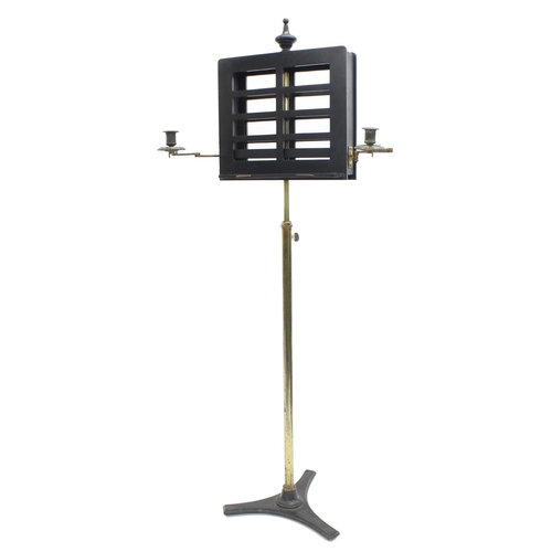 1566 - Victorian duet adjustable music stand, the ebonised ledges fitted with two folding candle sconces, u... 