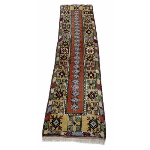 1127 - Turkish type multi-coloured runner, decorated with a central geometric strip within a wide geometric... 