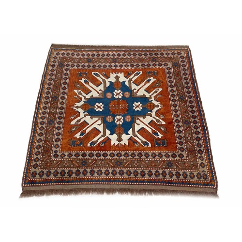 1128 - Persian pattern Karabakh style rug, on a red ground with a large central motif within repeated natur... 