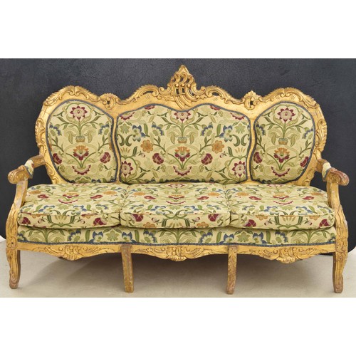 1138 - Decorative large gilt settee, the scrolling shaped back over a triple panel upholstered back over sc... 