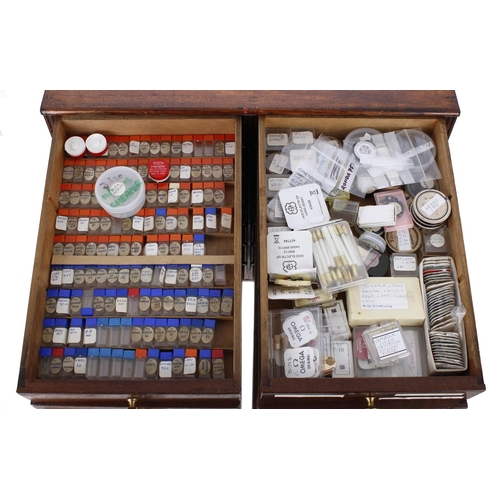 498 - Fourteen drawer wooden chest containing a large quantity of watchmakers parts to include Omega parts... 