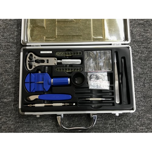 1056 - Carry case containing a quantity of watchmakers tools to include a case opener, case knife, strap pi... 