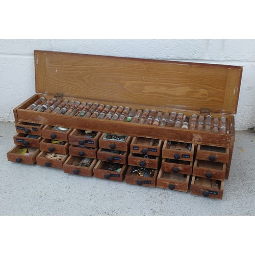 1021 - Watchmaker's twenty one drawer wooden chest with hinged top containing a quantity of parts and acces... 