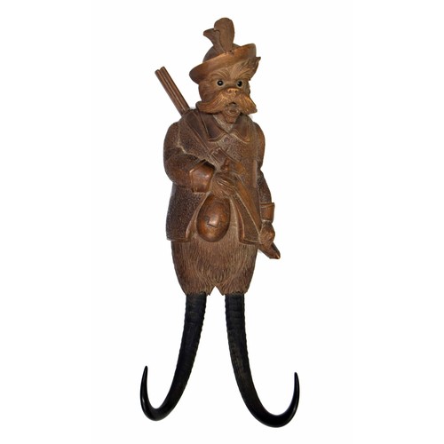 1391 - Novelty Black Forest musical coat hook carved as a dog in hunting apparel with rifle strapped over h... 