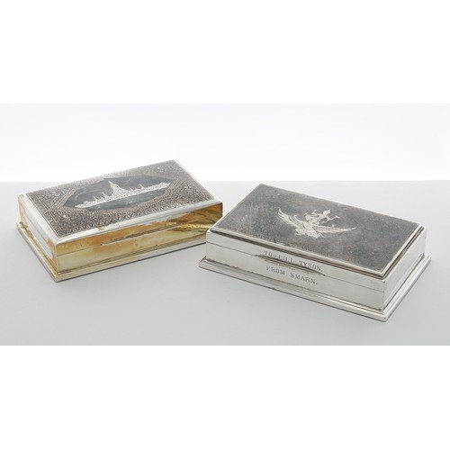 534 - Two similar Thai white metal boxes, with Niello type decorated covers with buildings and a goddess f... 