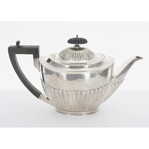 504 - Edwardian silver teapot, with a hardwood handle and finial over a half reeded body, maker Rober... 