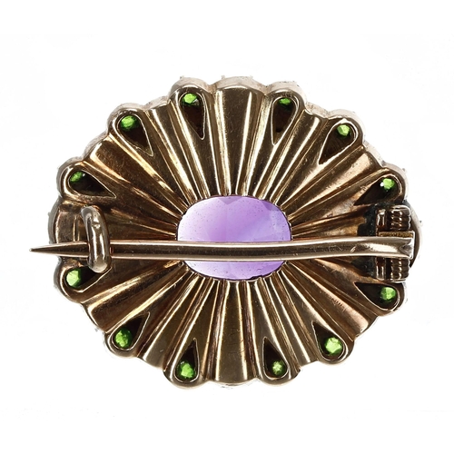 338 - Attractive 'Suffragette' oval gold brooch, set with an oval amethyst in a border of pearls each set ... 