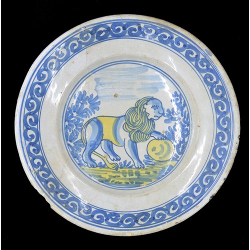 580 - Dutch Delft pottery plate, decorated with a blue lion on a white ground highlighted in yellow to the... 