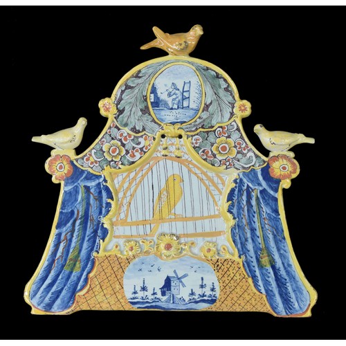 581 - Dutch Delft pottery bird cage plaque, polychrome decorated with a bird in a cage behind blue drawn c... 