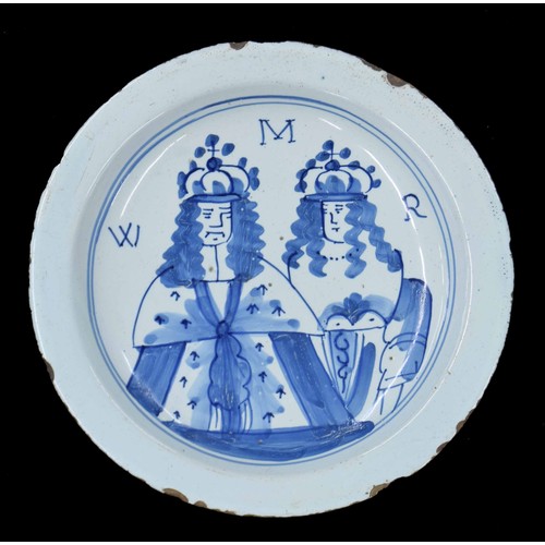 Rare English Delft pottery William and Mary commemorative plate, circa 1690, decorated in blue with the half length portraits and initialled WMR, within a double line border, 8.5" diameter (chips and losses)
