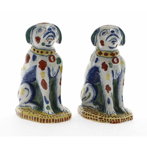 579 - Pair of 18th century Dutch Delft pottery dog figures, freely painted with polychrome decoration, on ... 