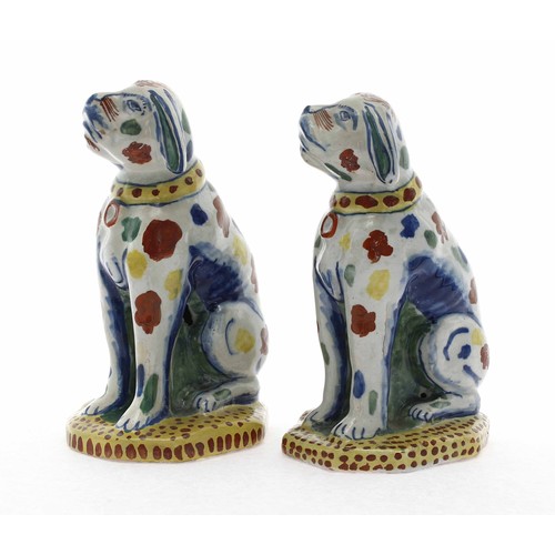 579 - Pair of 18th century Dutch Delft pottery dog figures, freely painted with polychrome decoration, on ... 