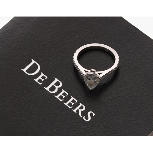 389 - Fine De Beers pear shaped platinum solitaire diamond ring with diamond pavé shoulders, the pear diam... 