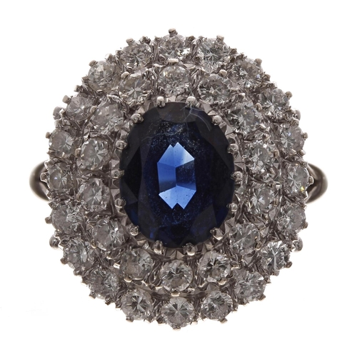 390 - Large 18ct white gold sapphire and diamond cluster ring, the oval sapphire 2.60ct approx, in a two-t... 