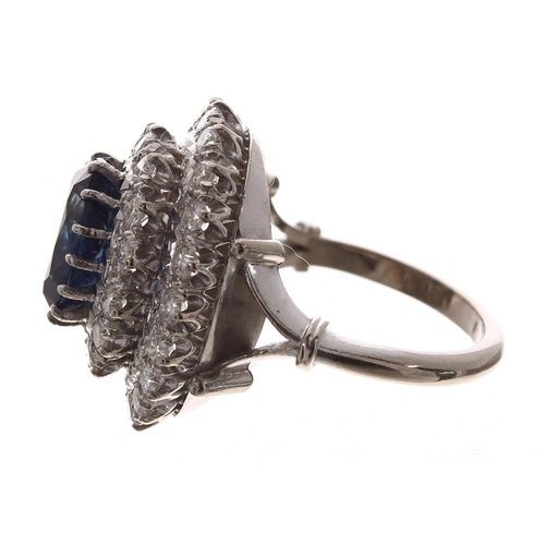 390 - Large 18ct white gold sapphire and diamond cluster ring, the oval sapphire 2.60ct approx, in a two-t... 