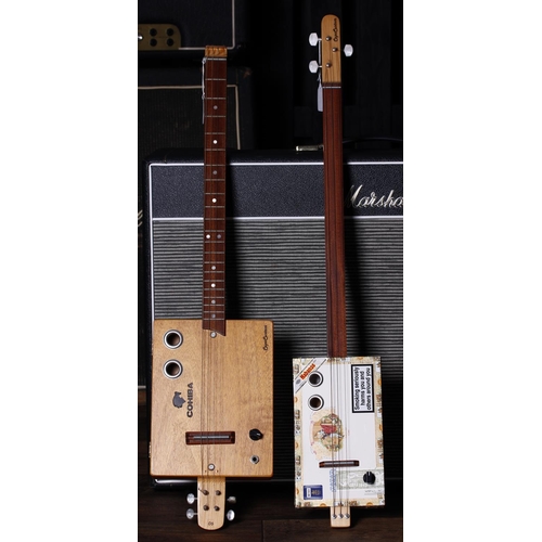 Capo Custom headless four string cigar box guitar together with a