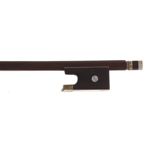 2253 - Nickel mounted violin bow, unstamped, the stick round, the ebony frog inlaid with pearl eyes and the... 