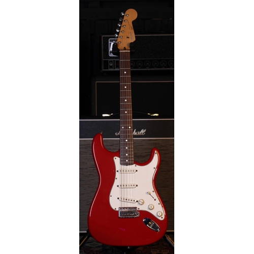 790 - Squier by Fender Stratocaster electric guitar, made in Japan; Body: red finish, surface scratches an... 