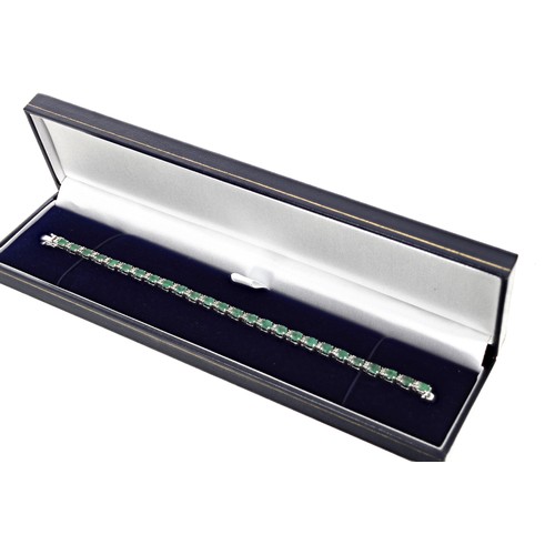 348 - Modern 18ct white gold line bracelet, set with emeralds and diamonds with an open box clasp and doub... 