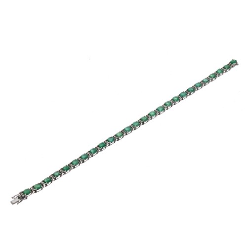 348 - Modern 18ct white gold line bracelet, set with emeralds and diamonds with an open box clasp and doub... 