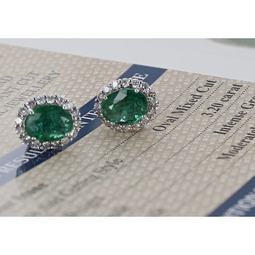 8 - Pair of certificated 18ct white gold oval emerald and diamond cluster stud earrings, the emeralds 3.... 