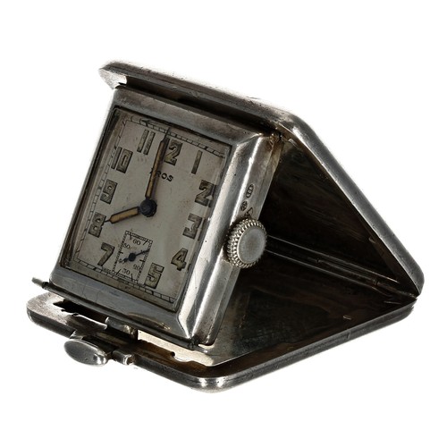 628 - Eros square silver travel purse watch, import hallmarks London 1935, the folding engine turned and e... 