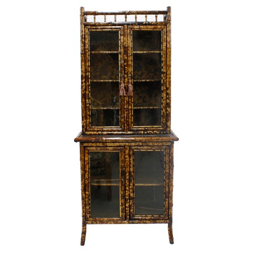Good Victorian bamboo display cabinet, the upper section with two glazed doors enclosing a shelved interior, over a base section with two glazed doors enclosing a shelved interior, the side panels and shelves with faux shallow relief effect paper, 31" wide, 18" deep max, 73" high