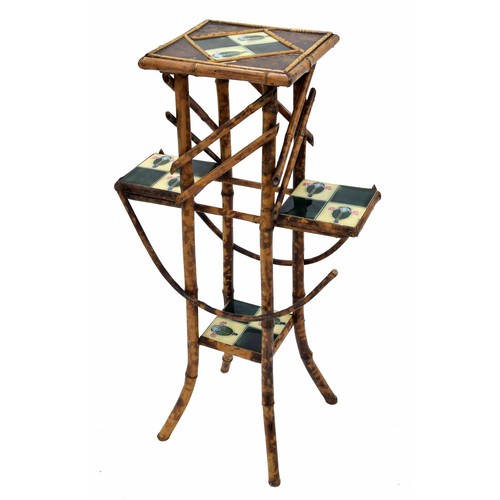 Good Art Nouveau bamboo plant stand/whatnot, with stylised leaf motif tile inset top and shelves, 36" high
