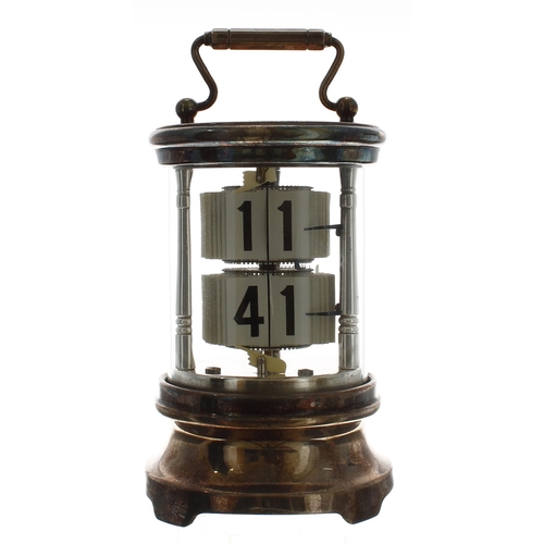 2502 - Silver plated ticket clock, within a cylindrical glazed case with fixed key wind beneath and surmoun... 