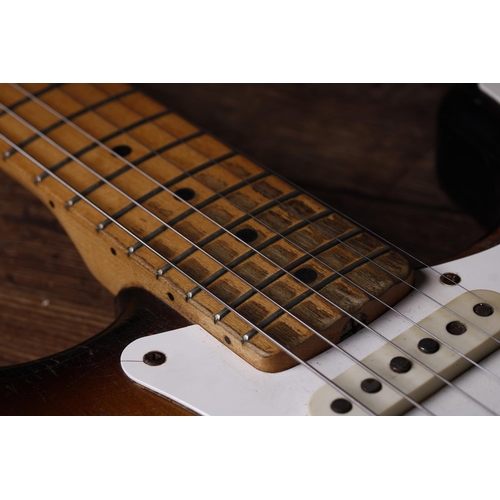 55 - 1957 Fender Stratocaster electric guitar, made in USA; Body: two-tone sunburst finish, checking thro... 