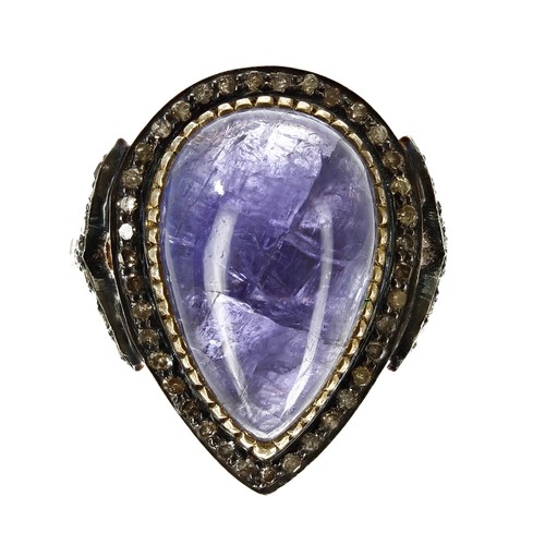 100 - Pear-shaped cabochon tanzanite and diamond-framed ring set in gold plate silver, the tanzanite 10.18... 