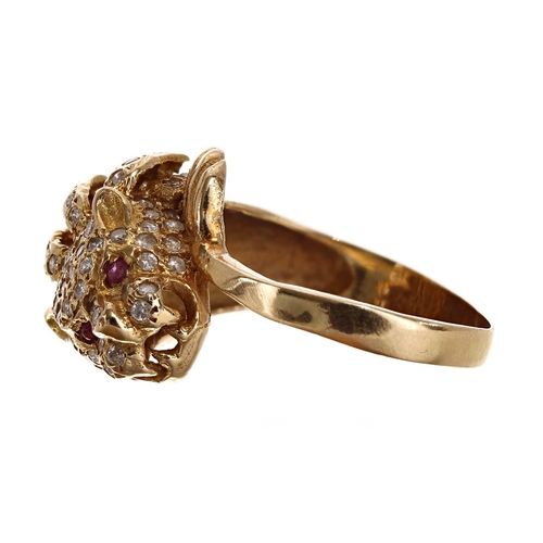 142 - Yellow gold diamond set lion head ring, with ruby set eyes, 16mm, 7.4gm, ring size O/P (17)... 