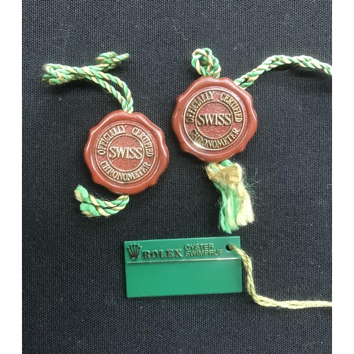 450 - Rolex - Two Rolex red tags; together with a Rolex Oyster Swimpruf tag (3)